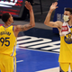 Steph high-fives some dude in the same jersey.